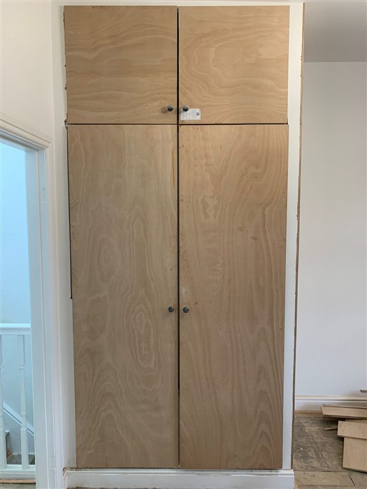 Tall made-to-measure cupboard with plywood doors