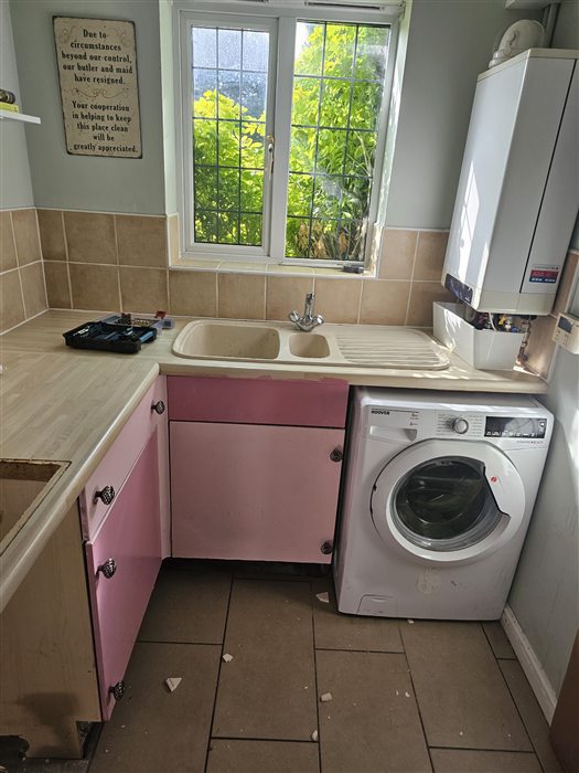 Kitchen before: pink laminate doors and worn worktop
