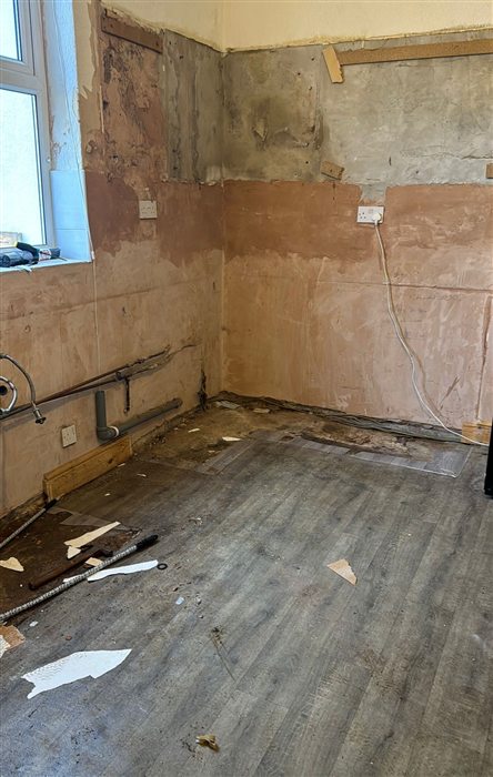 Kitchen stripped back to bare walls before re-plastering