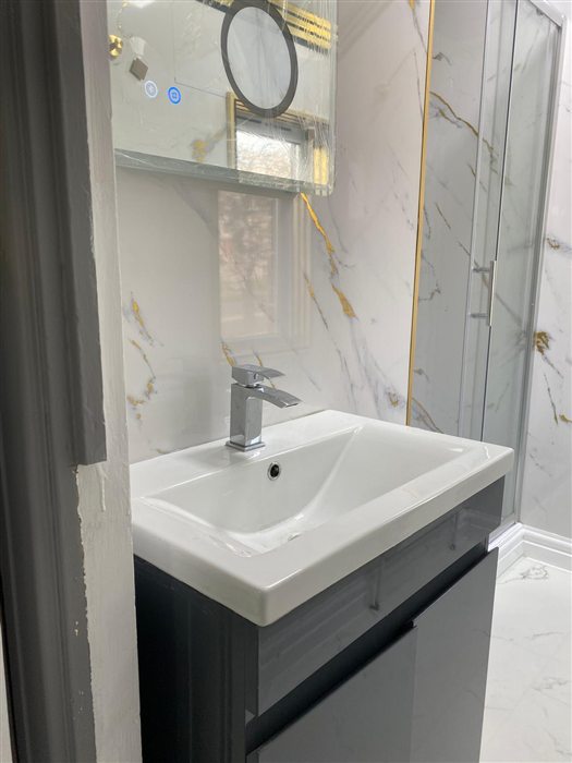 Vanity unit with basin and illuminated mirror