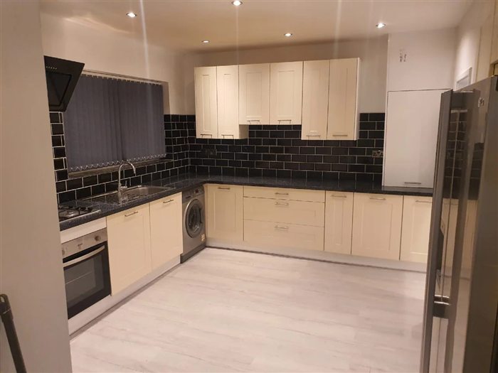 Cream shaker kitchen with black metro tiles