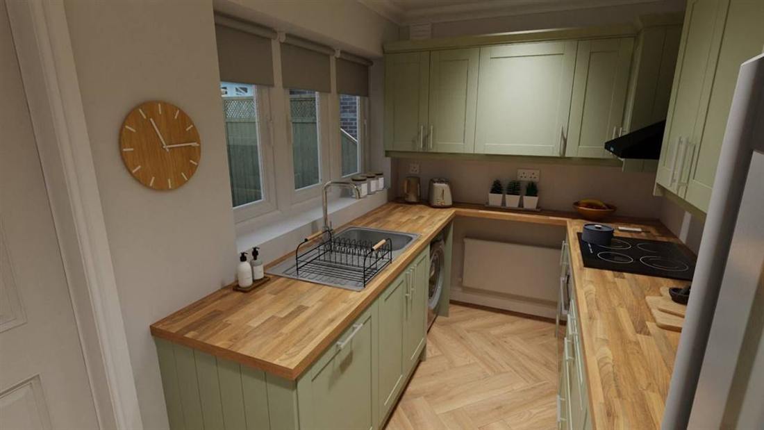 Green shaker kitchen with oak worktops and brass-look handles