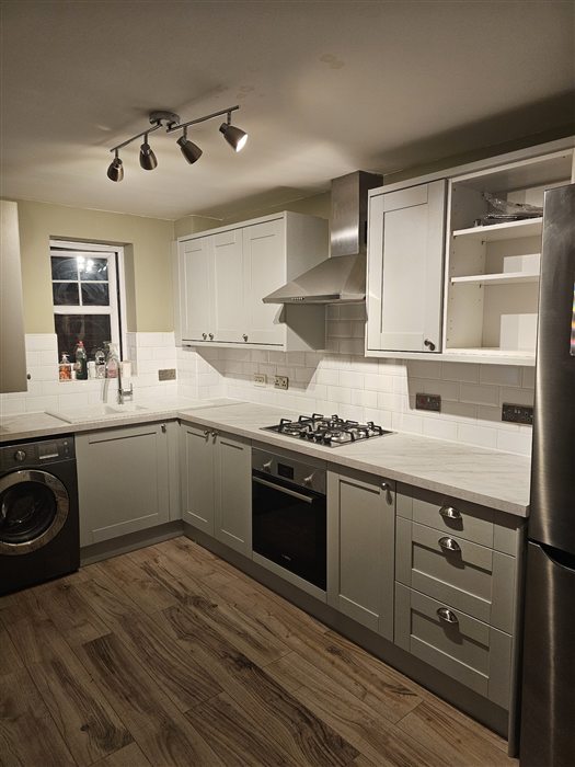 Grey shaker kitchen with wood-effect flooring