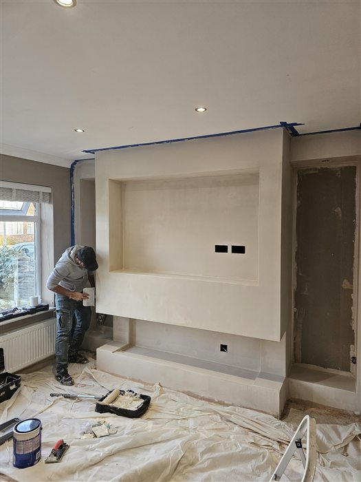 Plasterer skimming a new feature wall
