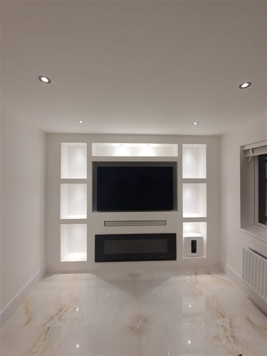 White media wall with lit shelving niches