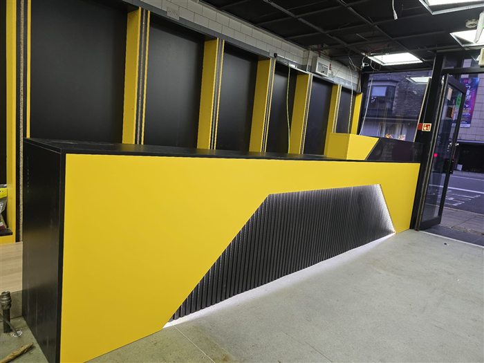 Yellow and black shop counter with LED lighting