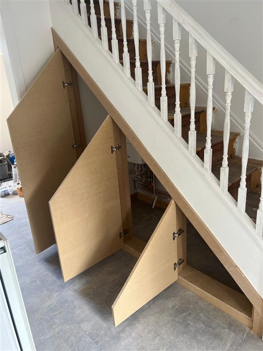 Made-to-measure under-stairs cupboards with oak-effect doors