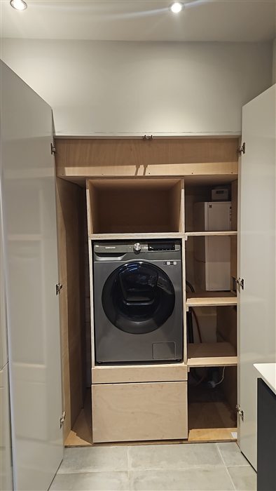 Utility cupboard housing a washing machine